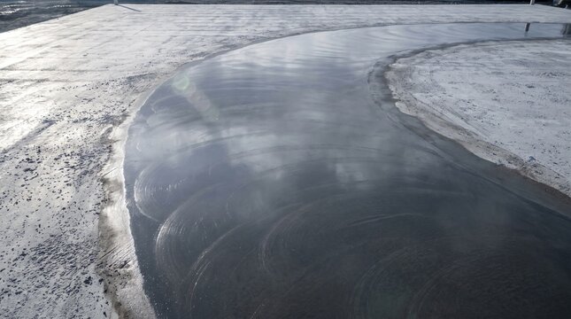 A power float pan burnishing a slab to a dark sheen