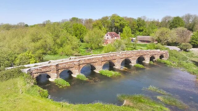 White Mill and Old Bridge over River Stour from a drone, Sturminster Marshall, Dorset, England