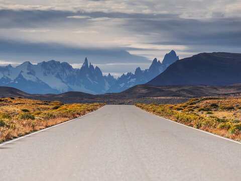 Empty straight road leading to Fitz Roy mountains copy space