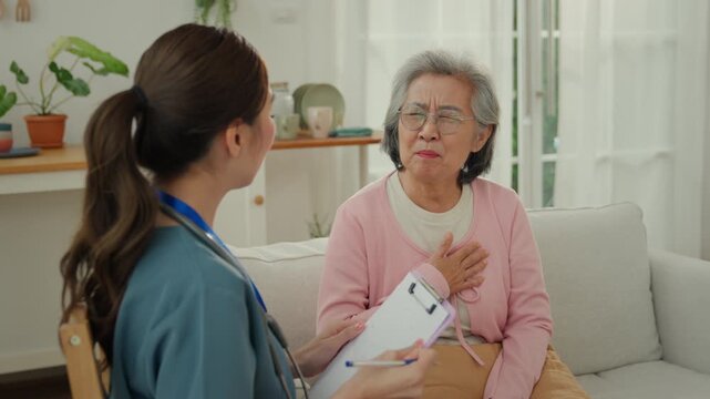 Elderly caregiver nursing home care support in home setting with senior woman and nurse during health check consultation and heart pain concern