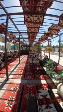 View from a traditional outdoor majlis seating area showing Masjid Quba in Medina.