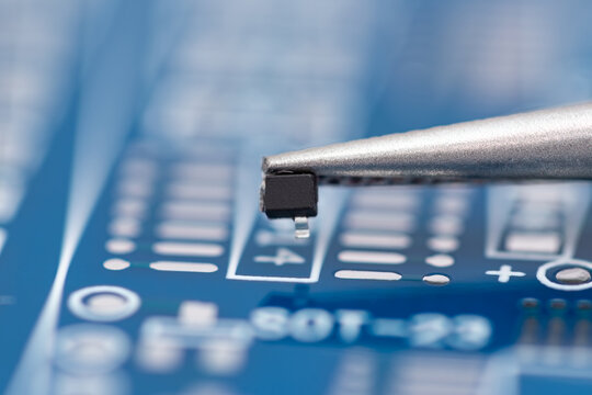 Tiny electronic component rests on a circuit board