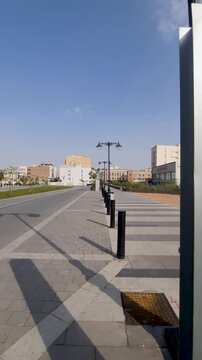 A 2.2 km distance marker sign to Masjid Quba on sunny pedestrian walkway in Medina.