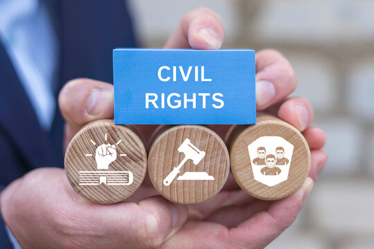 Concept of civil rights. Know your rights. Civil participation. Person holding blocks with icons sees the text CIVIL RIGHTS on blue parallelepiped.