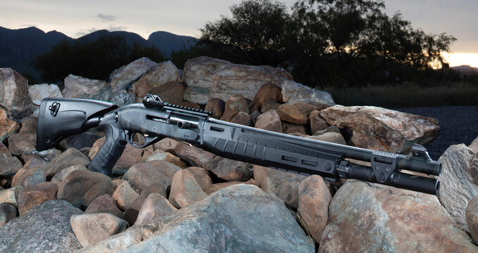 Tactical 12 gauge shotgun outdoors at sunset