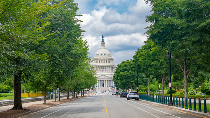 Cloudy sky frames the iconic Capitol dome in Washington DC during summer. © kosoff