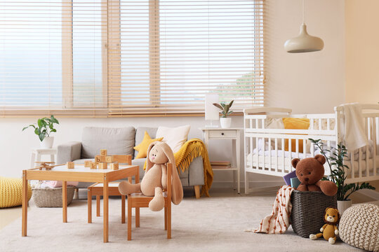 Childhood development and nursery interior, cozy playroom with baby crib and wooden toys for early learning and creative play in a modern home