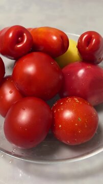 Fresh and vibrant heirloom tomatoes on a clear glass plate