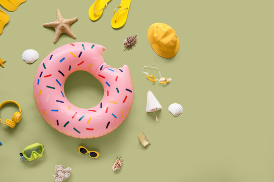 Summer vacation and travel planning, flat lay of beach accessories and donut pool float on green background for holiday leisure and tourism