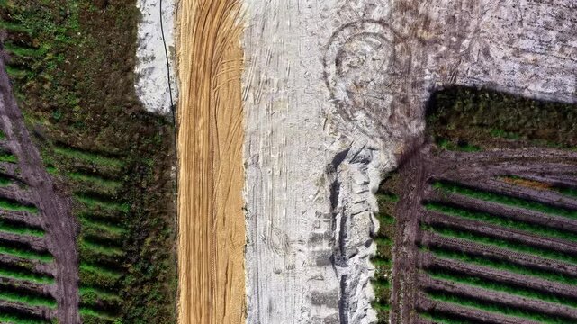 Aerial view of the industrial landscape and earthworks surrounding the Patnow Power Plant in Konin, Wielkopolskie, Poland.