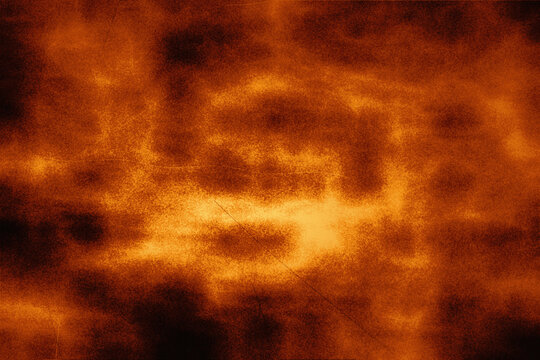 Vibrant burnt orange abstract background with smokey dark layers and vintage texture scratches for intense energy design projects and artistic atmosphere.