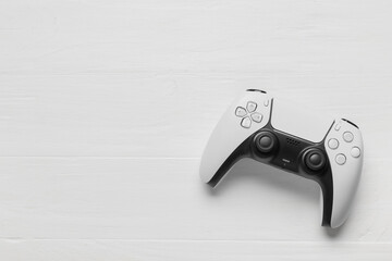 Gaming and entertainment industry, modern wireless game controller on a white wooden background for digital leisure and interactive media concepts © Pixel-Shot