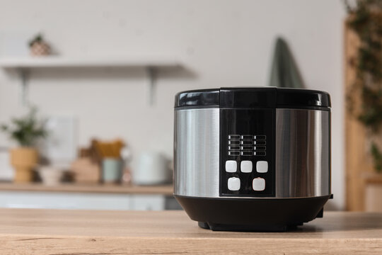 Healthy cooking and meal preparation, modern electric multicooker on a wooden kitchen counter for easy home food recipes and nutrition lifestyle