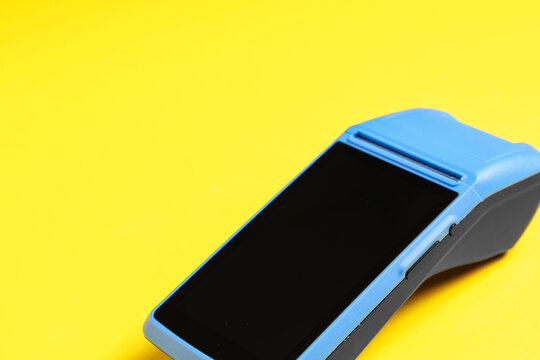 Payment terminal on yellow background
