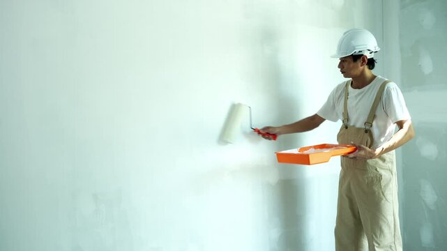 painter man, brush in hand for products to restore and paint the wall, indoor the building site of a house, wall during painting, renovation, painting, contractor, Architect, construction worker