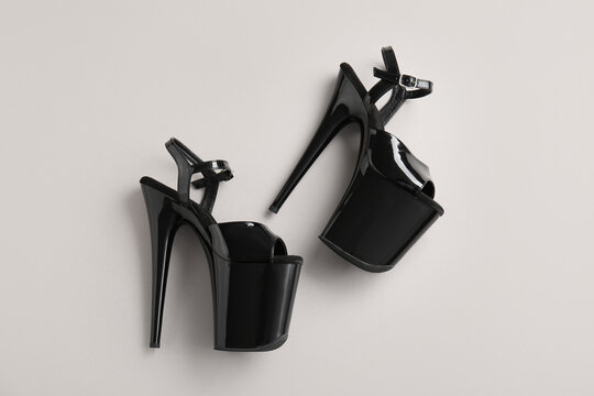 Stylish black high heels for pole dance on grey background