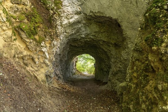 Tunnel in the rock on the hiking trail around the Lac des Moron reservoir between Switzerland and France