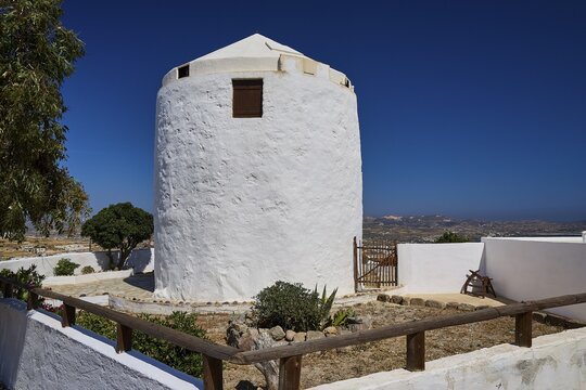 Round white windmill with fenced courtyard and views of surrounding countryside, Trypiti, Tripiti, village, Milos, island, Cyclades, Greek Islands, Greece