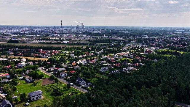 Aerial view of the Orlen Plock Production Plant with industrial chimneys and surrounding residential areas in Plock, Mazowieckie, Poland.