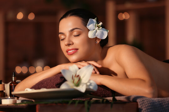 Young woman relaxing in dark spa salon, closeup
