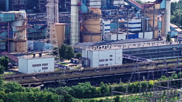 Aerial view of ZE PAK SA Patnow Power Plant with industrial buildings, cooling towers, and railway tracks in Konin, Wielkopolskie Voivodeship, Poland.