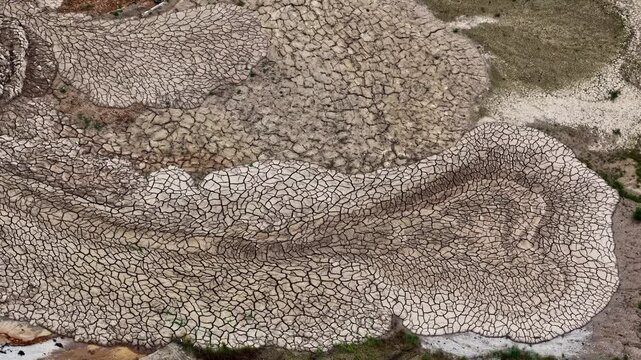 Aerial view of the cracked, dry earth at Tagebau Hambach showing intricate patterns of parched soil in Elsdorf, Nordrhein-Westfalen, Germany.