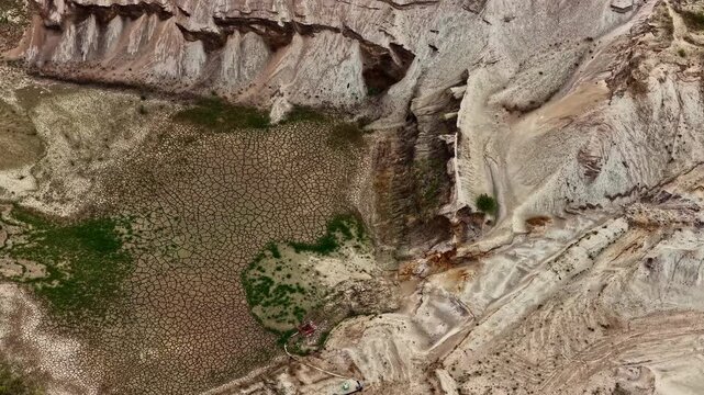 Aerial view of the dry cracked earth and deep excavation layers of the Tagebau Hambach open-pit mine in Elsdorf, Nordrhein-Westfalen, Germany.