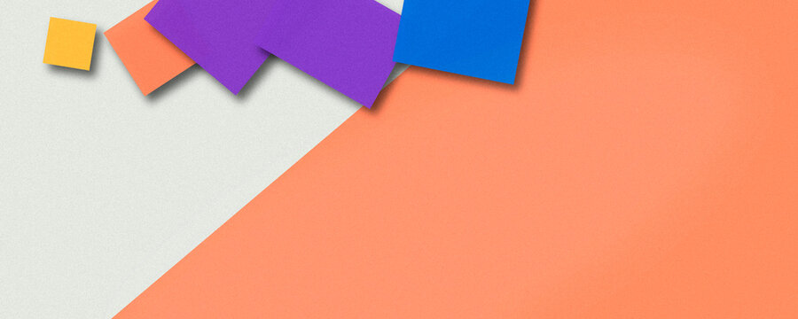 Colorful square paper pieces scatter across a light gray field next to a smooth orange diagonal, offering a lively spot for text overlays in marketing layouts.