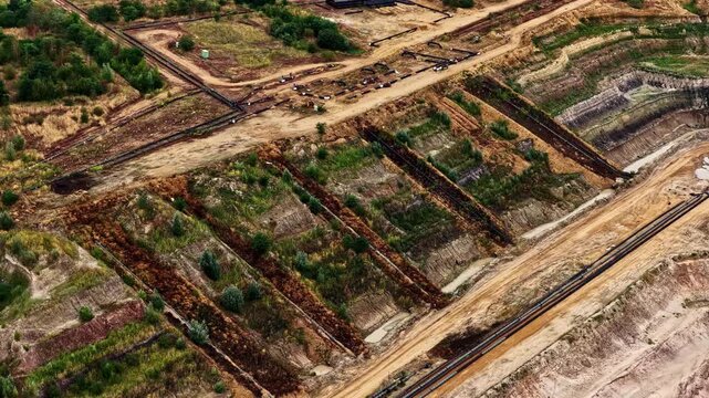 Aerial view of the vast Tagebau Hambach open-pit mine showing terraced slopes, industrial excavation infrastructure, and earthworks in Elsdorf, Nordrhein-Westfalen, Germany.