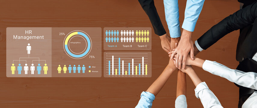 Hands join together in unity while showcasing hr management charts and statistics on a wooden table, emphasizing teamwork, collaboration, and strategic planning. Ledger