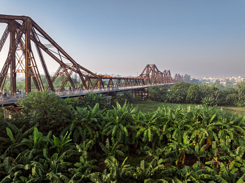 Long Bien Bridge over a banana plantation in Hanoi, Vietnam