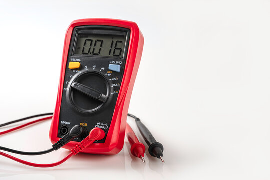 Digital Multimeter with Probes Isolated on White . professional red digital multimeter displaying voltage readings, shown with black and red testing probes.