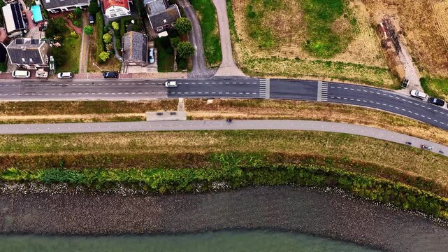 Aerial view of the historic Kinderdijk UNESCO World Heritage site with its dike, road, and waterway in Kinderdijk, Zuid-Holland, Netherlands.
