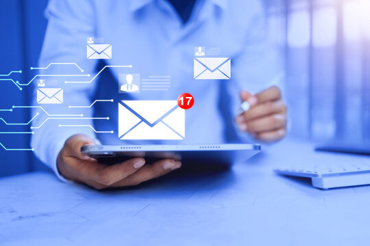 business e-mail concept with businessman using tablet to inbox new mail checking on working desktop
