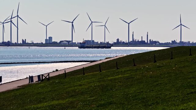 Aerial view of wind turbines near the Volkswagenwerk Emden industrial site along the coast in Emden, Niedersachsen, Germany.