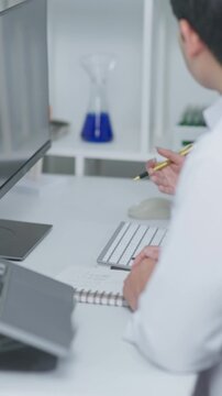 Doctors discussing medical diagnosis and treatment plan in a clinic office, reviewing patient information and healthcare documents together.