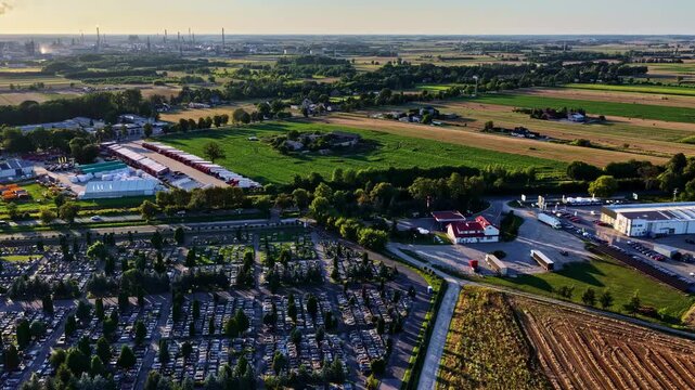 Aerial view of the Orlen Plock Production Plant and surrounding cemetery, agricultural fields, and industrial infrastructure in Plock, Wojewodztwo mazowieckie, Poland.