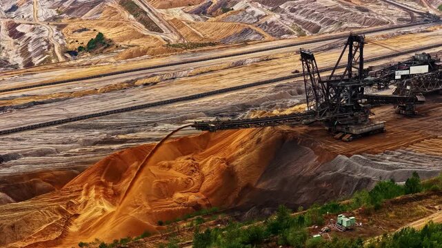 Aerial view of the massive Tagebau Hambach open-pit coal mine with a large bucket-wheel excavator operating in the industrial landscape of Elsdorf, Nordrhein-Westfalen, Germany.