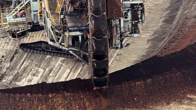 Aerial view of a massive bucket-wheel excavator operating at the Garzweiler surface mine, showing the industrial scale of coal extraction in Juchen, North Rhine-Westphalia, Germany.