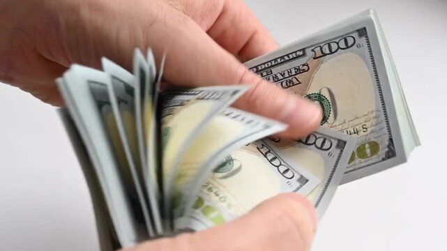Hands Counting Thick Stack of One Hundred Dollar Bills