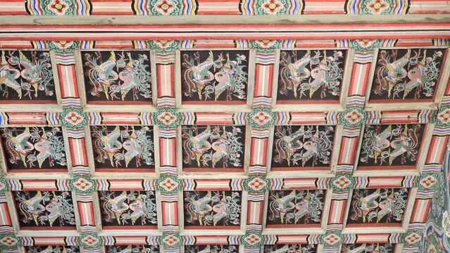 Intricate Dancheong painting on a traditional coffered ceiling (Umulbanja) at Changdeokgung Palace