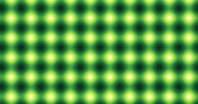 Abstract green and yellow glowing dot grid pattern with blurred luminous circles in symmetric rows
