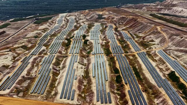 Aerial view of solar panels installed within the vast landscape of the Tagebau Hambach open-pit mine in Elsdorf, Nordrhein-Westfalen, Germany.