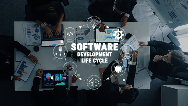 Team Collaboration on Software Development Life Cycle with Charts, Laptops, and Diverse Professionals Analyzing Data in a Modern Office Environment Quark.