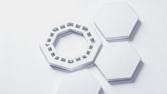 Modular white geometric components including hexagonal panels and a patterned octagonal ring, presented on a plain white background.