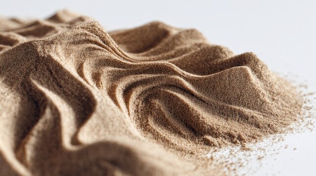 A close-up view of a small pile of dry sand, showing intricate patterns and shadows, creating a warm and organic aesthetic against a clean white backdrop.