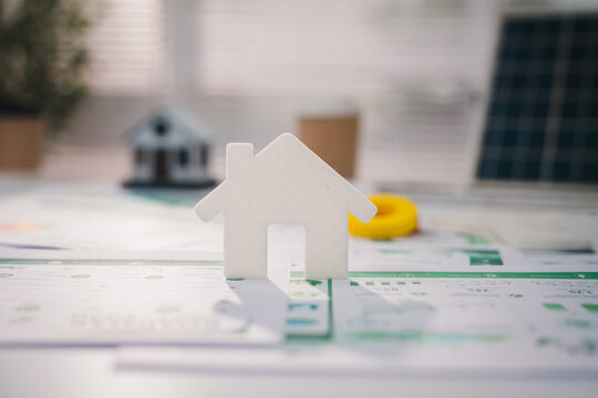 esg concept, White house model on property document with calculator and architectural background