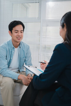 Financial advisor discussing wealth planning with smiling adult client during professional consultation in bright office setting