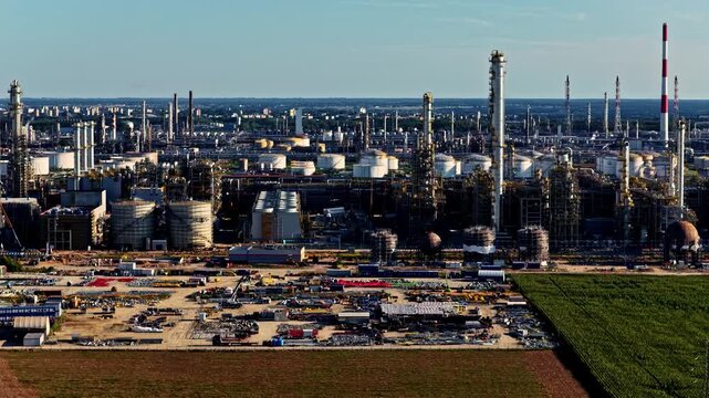 Aerial view of the Orlen Plock Production Plant with industrial towers, storage tanks, and surrounding fields in Plock, Mazowieckie, Poland.