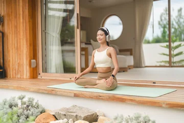 Young women wearing sportswear relax doing yoga workout trainer class at home, fitness and stretching exercise, home workout flexibility, gym, healthy lifestyle with cardio fitness, diet concept © Art_Photo